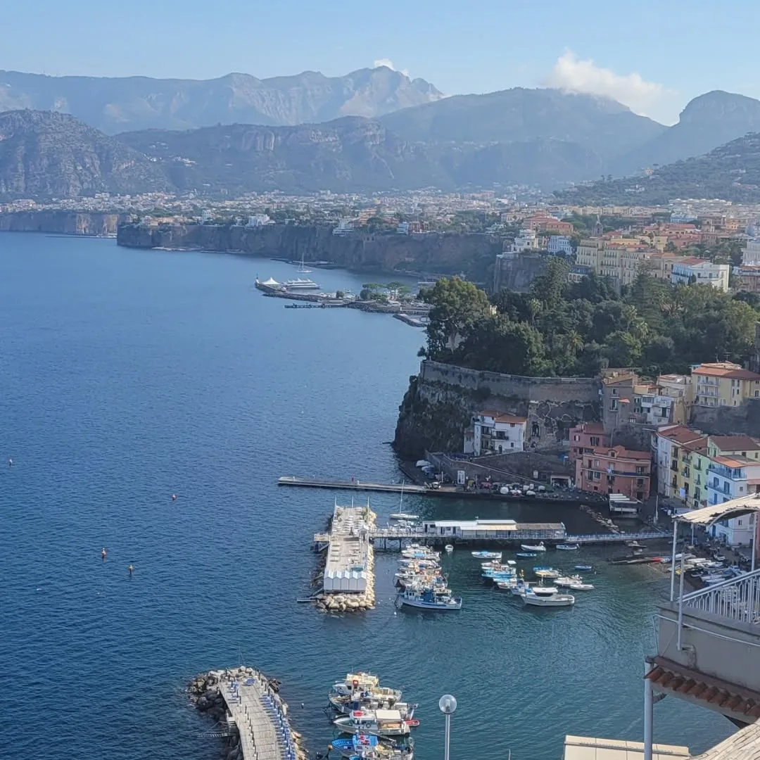 The Sorrento coastline with boats in the harbor below the cliffs